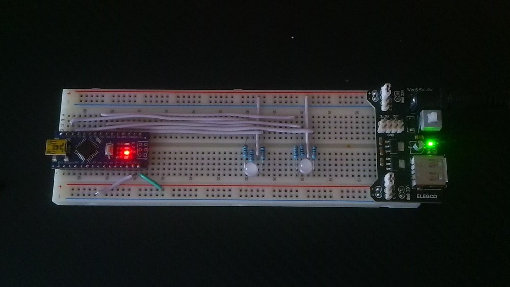 George’s breadboard with an Arduino Nano, two RGB LEDs, six resistors, jumper wires, and a breadboard power module.